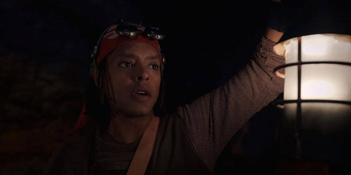 Usopp holding lantern in dark cave or tunnel