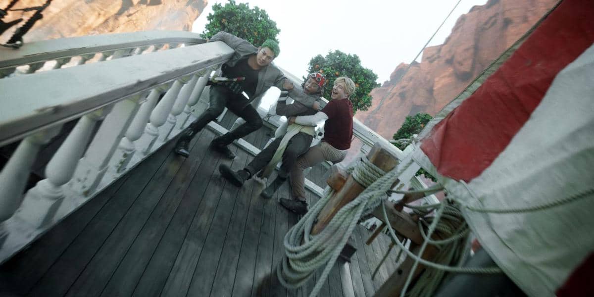 Zoro, Usopp, and Sanji holding on as ship tilts sharply