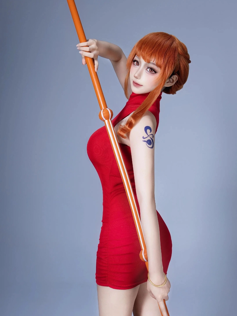 Nami cosplay in vibrant orange hair and stylish outfit