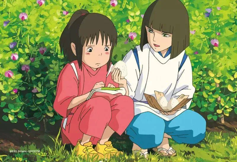 Scene of Chihiro receiving rice ball from Haku